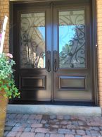 chocolate brown double entry doors with wrought iron and executive panels
