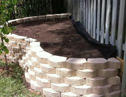 stone; edging; shrub; plant; mulch; flower bed; castlewall stone; retaining wall; rock; curb appeal