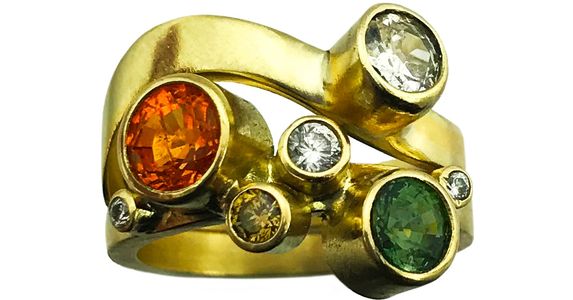 Custom stacking rings in 18k yellow gold with white diamonds, champagne diamonds, spessartite garnet