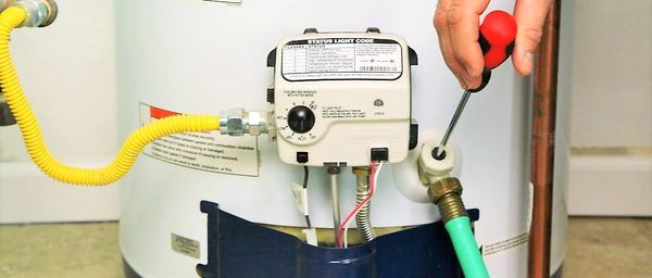 water heater displayed with homeowner preparing to empty tank.