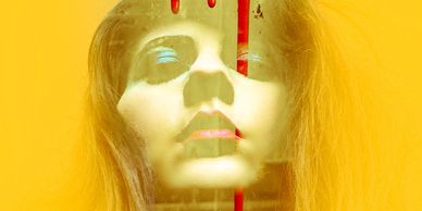 mary models artwork with bright yellow color and red paint drippings