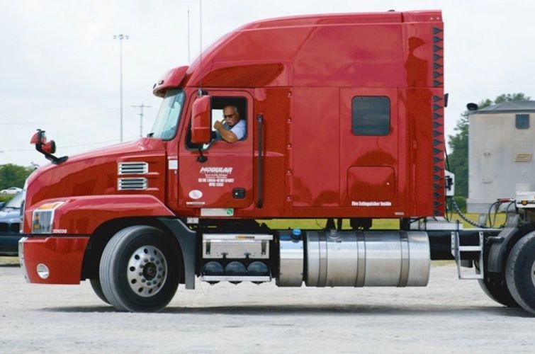 An experienced flatbed driver backing up to a trailer. John has been with Modular for 10+ years