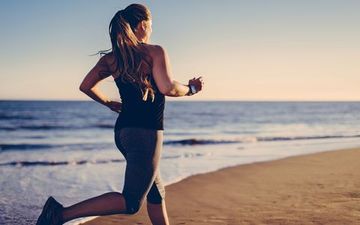 Fit woman exercising on the beach