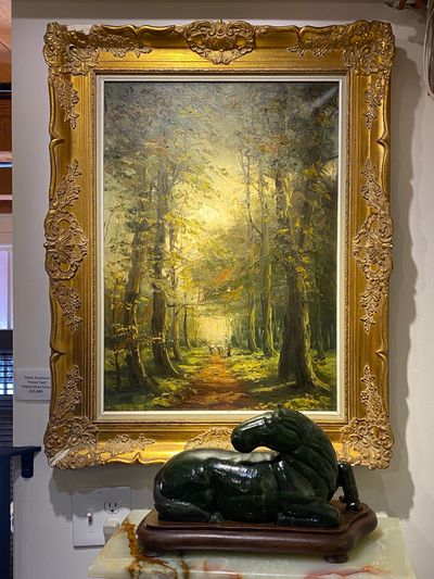 Oil painting of  forest in gold frame with horse sculpture 