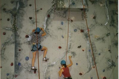 Indoor climbing wall in gymnasium of high school.
