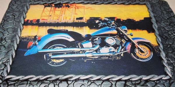 Grey cobblestone cake with a motorcycle edible image on the top