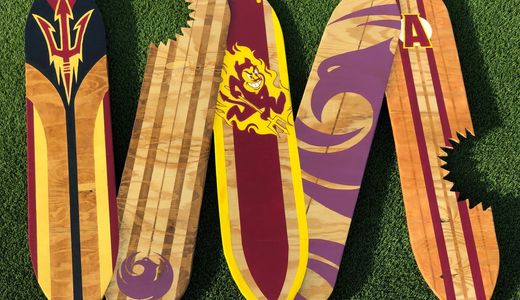 Wooden wall sculpture made to look like a group of Phoenix themed surfboards with shark attack scars