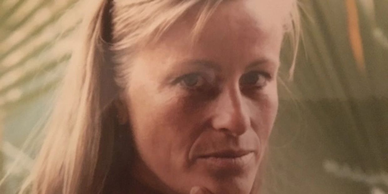Close-up of a woman with blonde hair and a thoughtful expression.