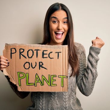 a girl holding a cardboard that says protect our planet