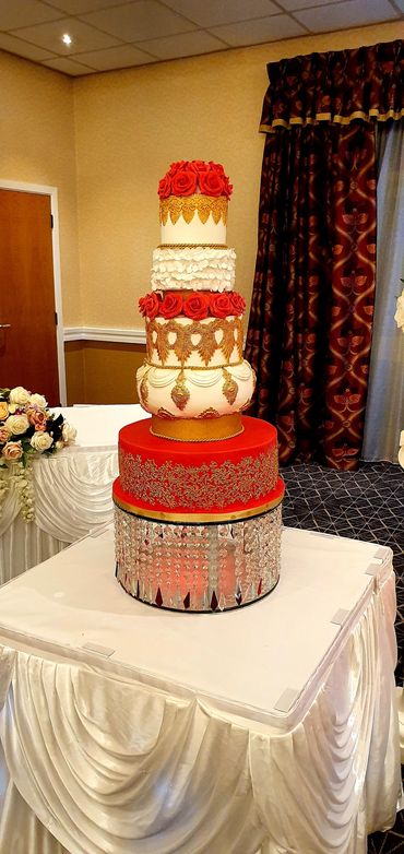 Asian wedding cake in Gold an Red theme with red roses and gold vintage design lace work