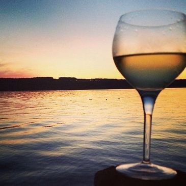 wine glass on a dock on seneca lake