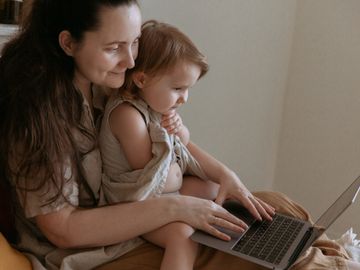 Woman and daughter on laptop together