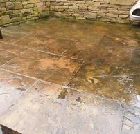 Grime & algae has made these patio slabs become dirty.