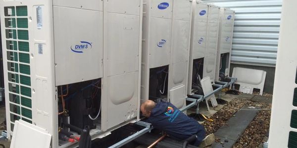 Worker fixing outside air conditioners