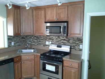 A rehabbed kitchen with appliances 