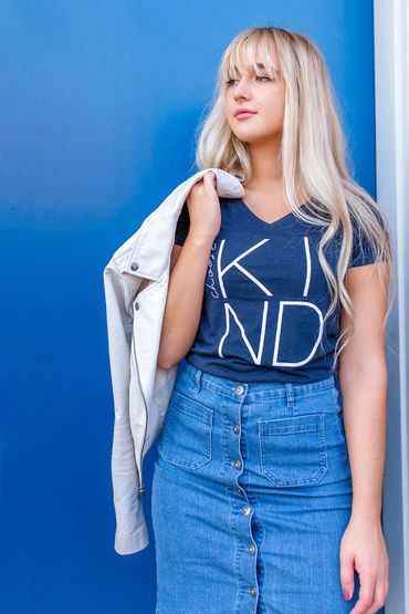 Model promoting kindness, dressed in a graphic choose kind t-shirt