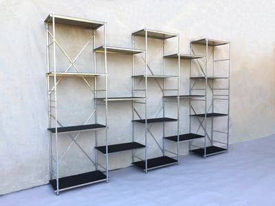Portable collapsible bookcase, 10' long x 6' high x 1' deep natural aluminum with black shelf liners.  Portable shelf display