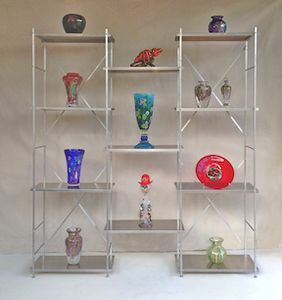 metal shelving portable display shelves 6' high by 6' wide by 1' deep, natural aluminum with blown art glass products on display.