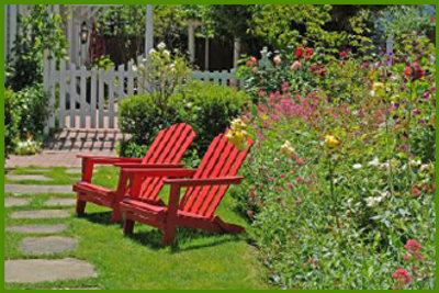 Two red chairs in a garden