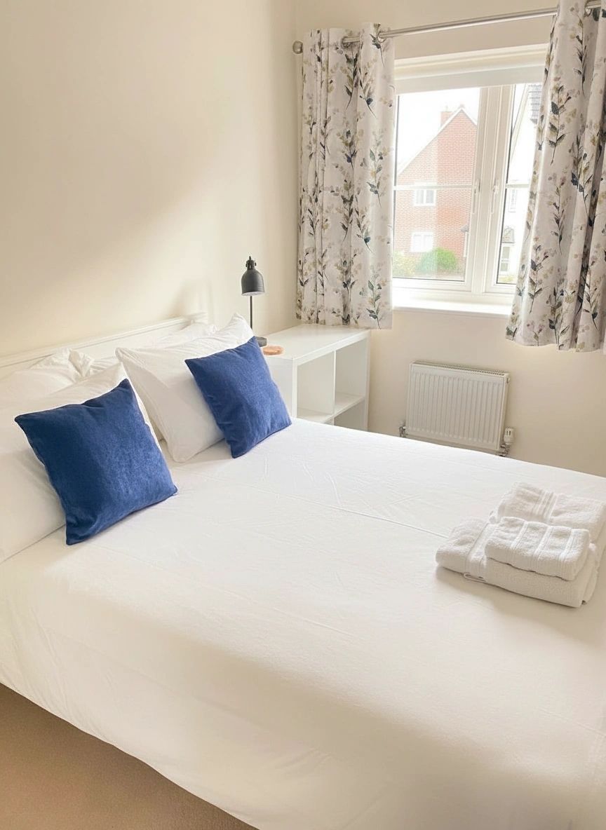 Freshly made bed with crisp white linen in an Oxford Airbnb