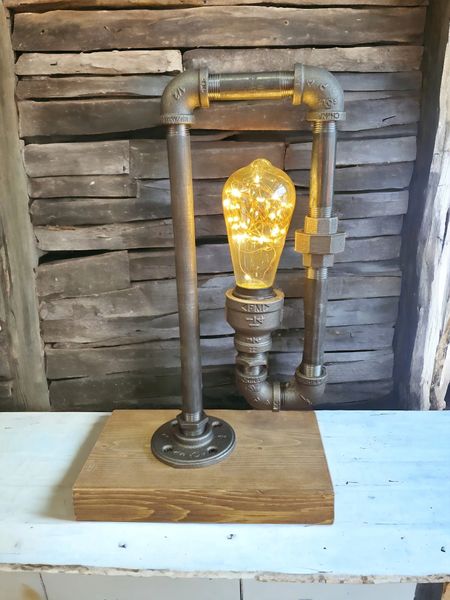 Edison curved lamp on pine board.