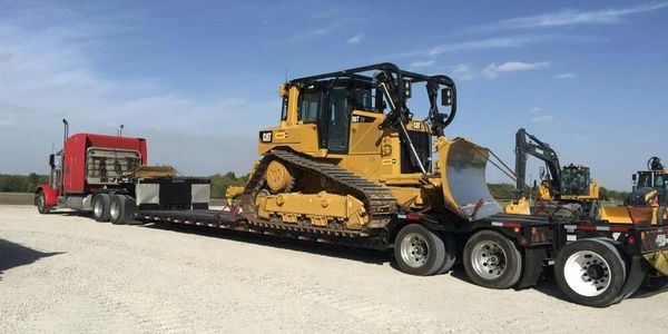 Hauling a construction bulldozer on a lowboy trailer