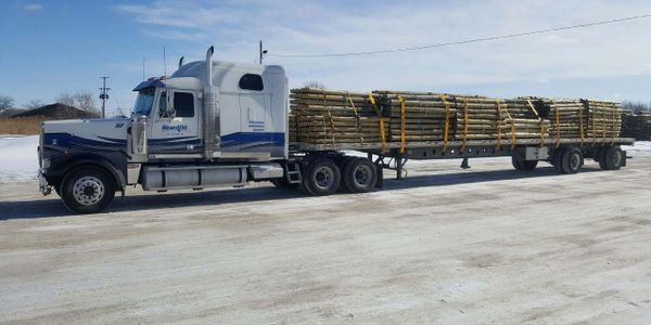 Hauling treated wood post's on a flatbed trailer