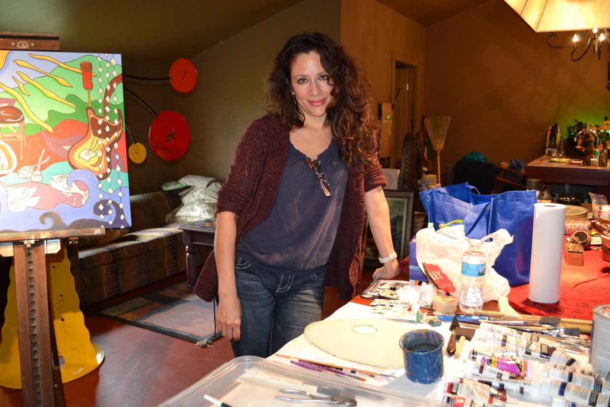 Artist Dalia Garcia smiling in art studio 