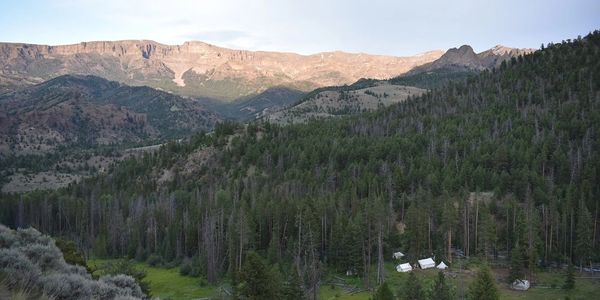 View of mountains and Elk Fork Outfitters wall tent camp in the Wyoming wilderness