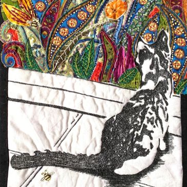 Chasingthejoy Art work. A hand and machine embroidered applique of a cat exploring the possibilities