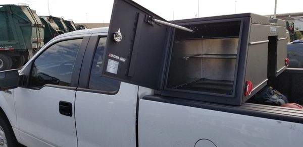Pickup truck toolbox with side access and removable shelves.