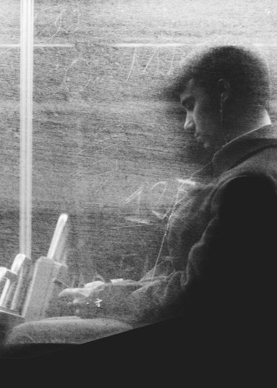 Thoughtful man seated on bus at night