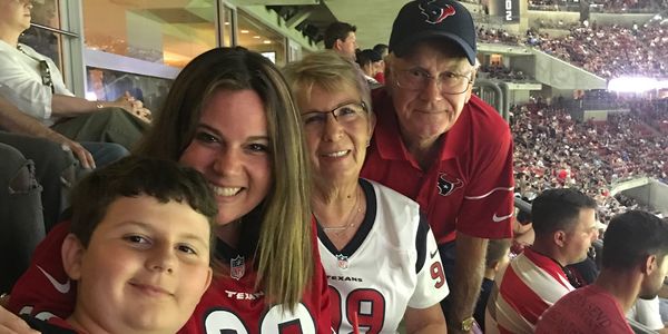 Owner of Katy Painting with his wife, daughter, and grandson at a Houston Texans football game. 