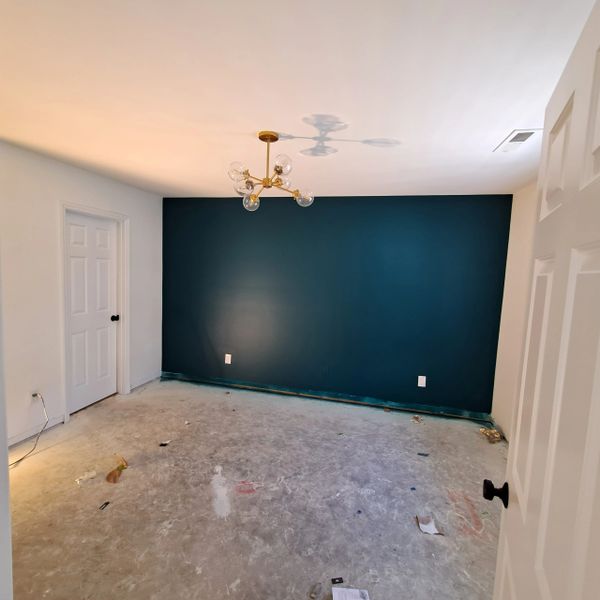 Blue Peacock accent wall in master bedroom with pure white walls and white ceilings
