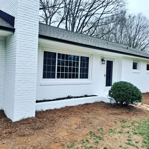 Pure white house with tricorn black gutters and door