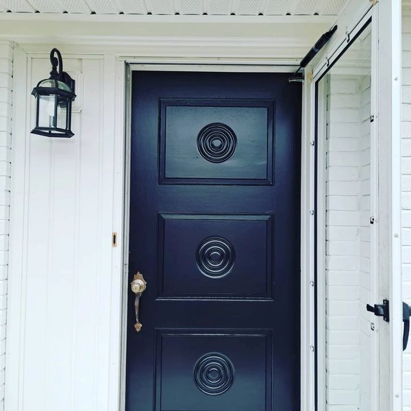 Tricorn Black Door with Pure white Siding and Brick