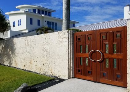 Custom Sapele wood gates with marble inserts for a Longboat Key home.