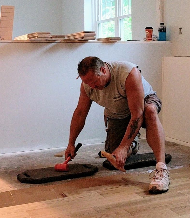 general contractor installing engineered wood floor in a new kitchen remodel