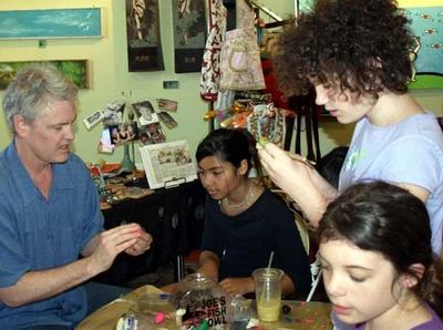 This is a picture of James Lloyd Jenkins teaching a class for children about polymer clay art.