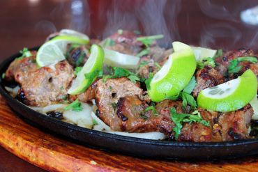 Sizzling Beef Bihari Kabab topped with lime and onion