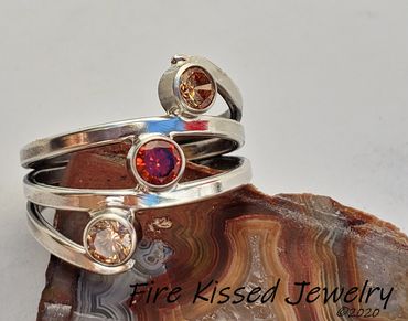 Mother's Ring featuring three faceted gemstones. 