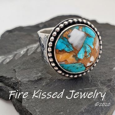 Coral and turquoise in bronze matrix cabochon, beaded frame and wide hammered sterling band.