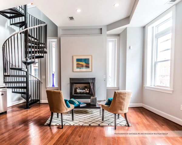 Modern living room with spiral staircase and cozy seating area.