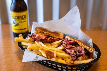 pastrami sandwich, fries, beer