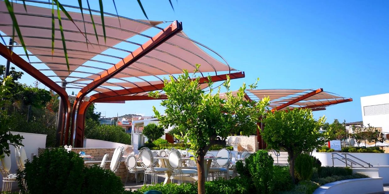 Shade canopy construction covered with shade cloth for sun shade at a hotel in Cyprus.