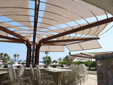 Sun shade canopy on a metal frame with shade sails providing sun shade by Shadeports Plus Cyprus.