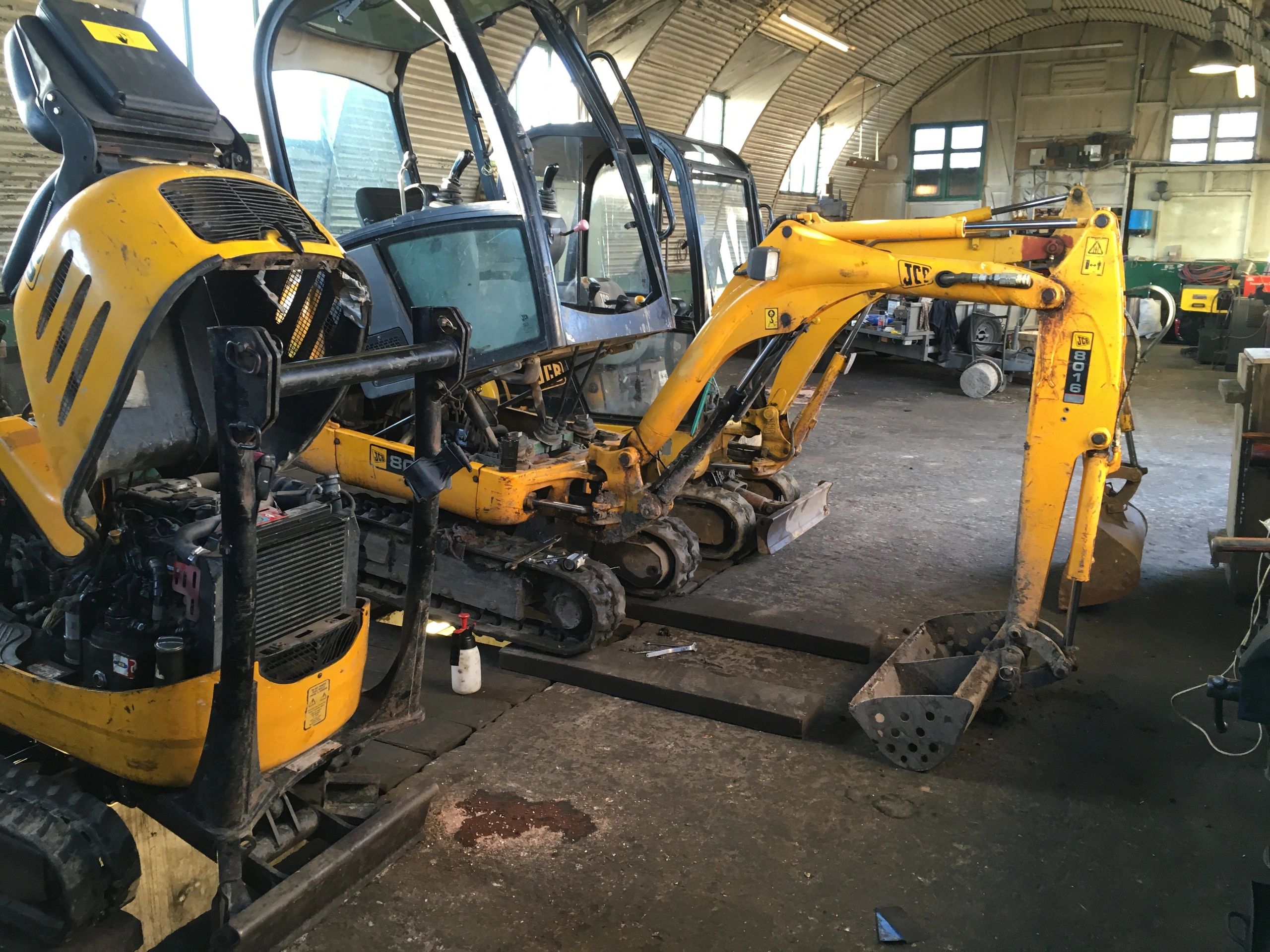 Three small machines awaiting service.