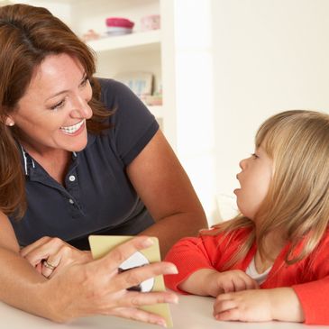 Therapist and child working on learning task.