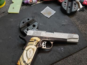 Another custom 1911 using a damascus slide another set of mammoth ivory grips