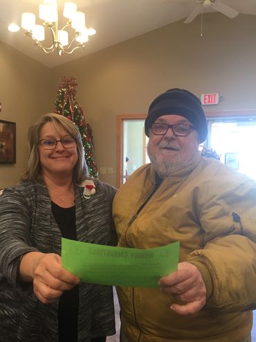 Paula Presenting Christmas Dinner Certificate to Jimmy, a local Vet.  